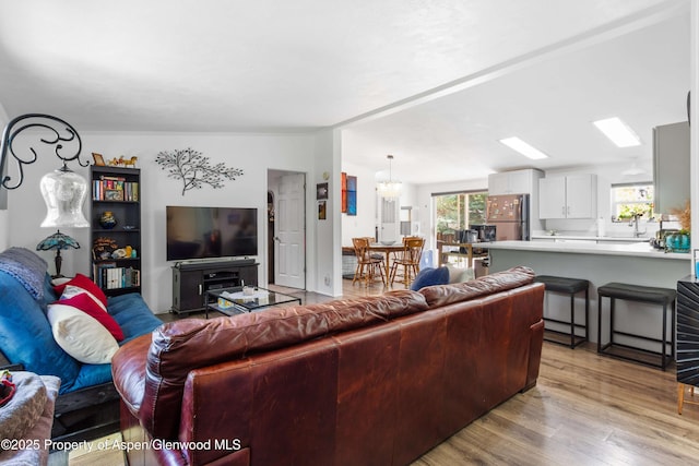 68 E Bonanza Pl, Parachute, CO 81635 - living area featuring light wood-style flooring and a chandelier
