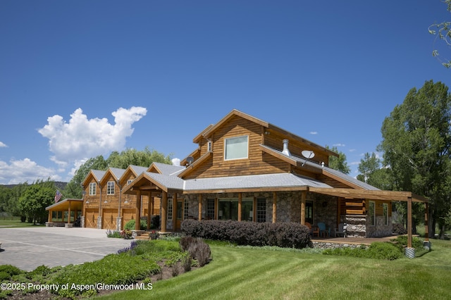 1207 Hooks Spur Rd, Basalt, CO 81621 - cabin with stone siding, a front yard, concrete driveway, and a porch
