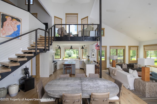 1207 Hooks Spur Rd, Basalt, CO 81621 - dining room featuring high vaulted ceiling, light wood-style floors, and stairs