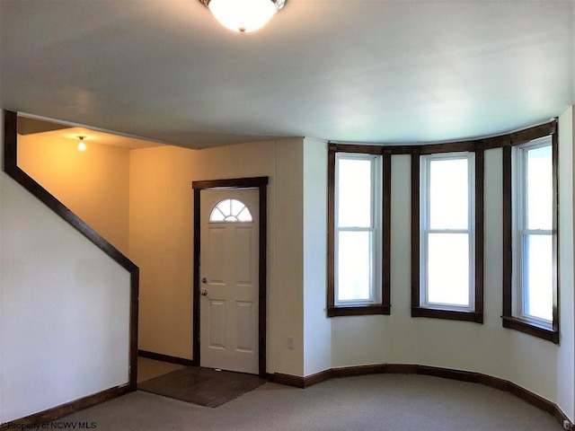 carpeted entryway featuring plenty of natural light
