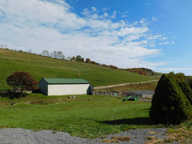 exterior space featuring a rural view and an outdoor structure