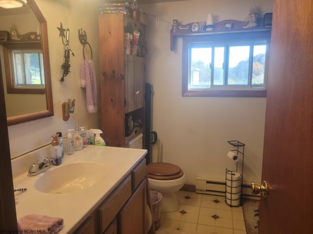 bathroom with tile floors, toilet, vanity, and a baseboard radiator