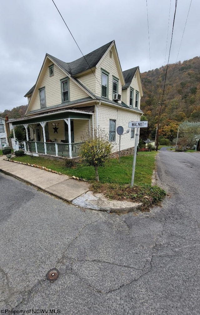 view of front of property with a mountain view and a porch