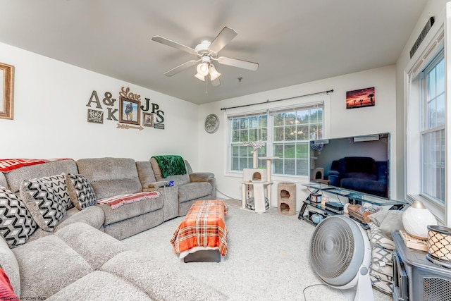 living room featuring light carpet and ceiling fan