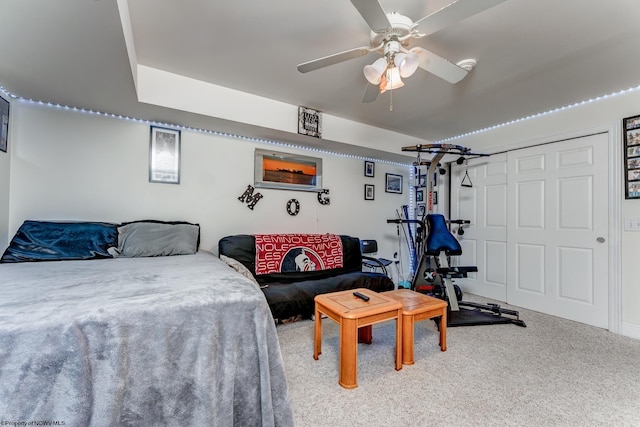 carpeted bedroom featuring a closet and ceiling fan