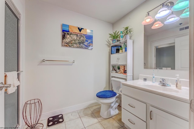 bathroom featuring tile floors, toilet, and vanity