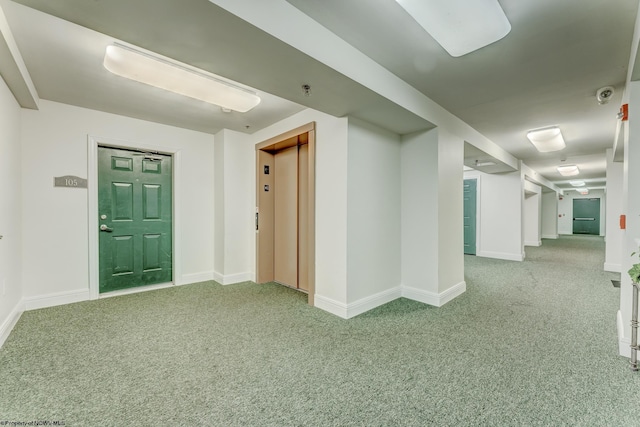 interior space featuring light colored carpet and elevator