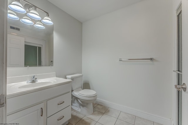 bathroom featuring toilet, tile floors, and vanity