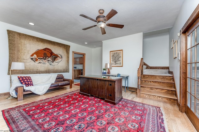 office space featuring ceiling fan, a textured ceiling, and light wood-type flooring