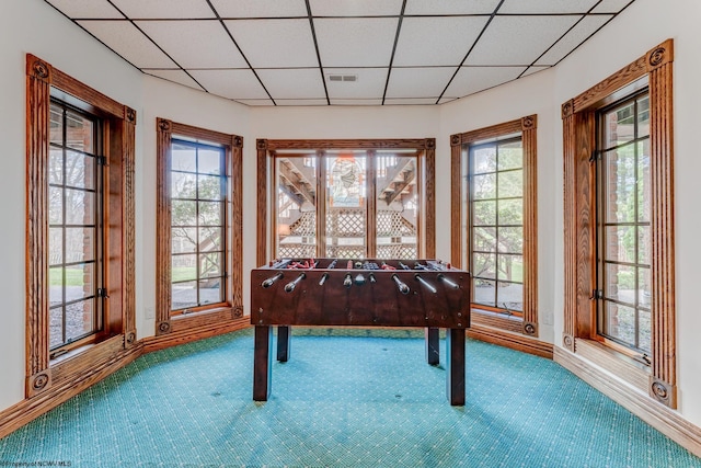 game room featuring a drop ceiling and carpet flooring