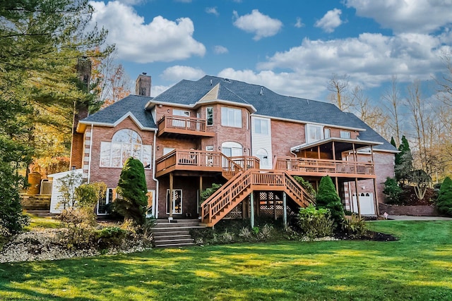 rear view of property featuring a balcony, a yard, and a deck