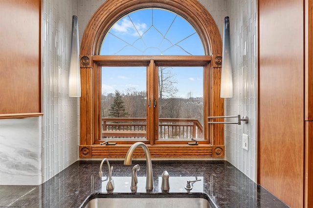 kitchen featuring dark stone countertops and sink