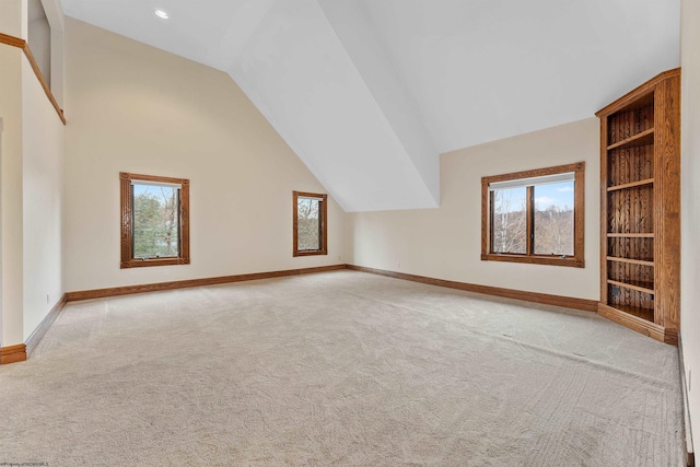 additional living space with vaulted ceiling and light colored carpet