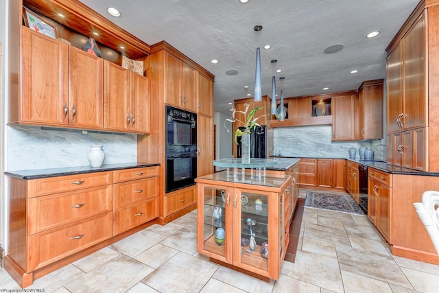 kitchen with backsplash, double oven, light tile flooring, dark stone counters, and a center island