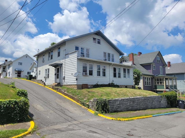 view of property featuring a front lawn