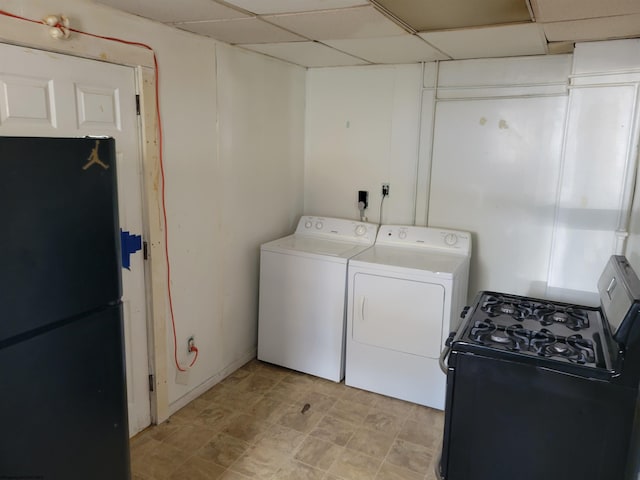 laundry room with light tile floors and washer and clothes dryer