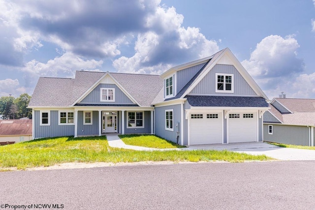 view of front of house featuring a front yard and a garage