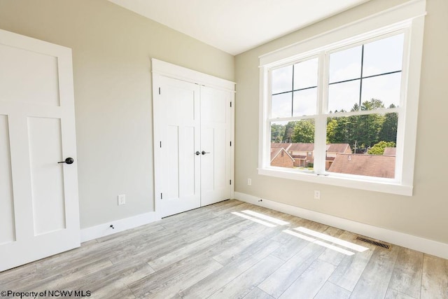 interior space with a closet and light hardwood / wood-style flooring