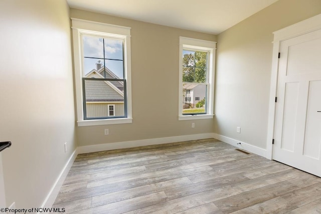 unfurnished room with light hardwood / wood-style floors