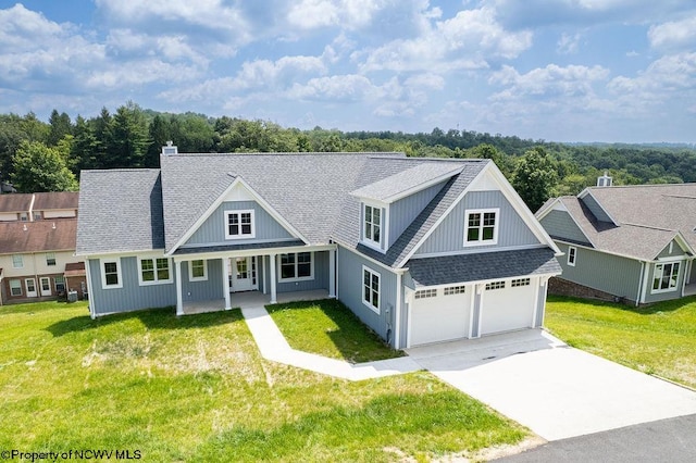 view of front of home featuring a front yard and a garage