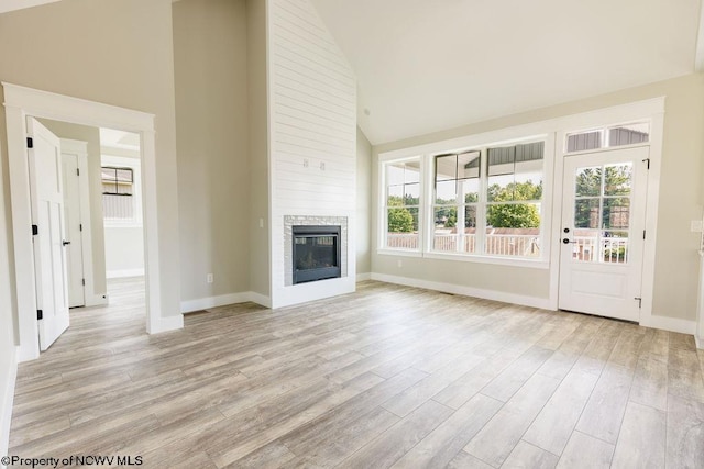 unfurnished living room with a wealth of natural light and light hardwood / wood-style flooring