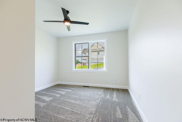 carpeted spare room with ceiling fan