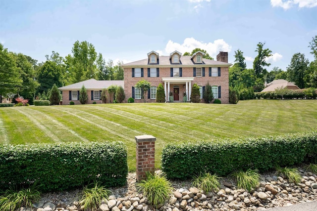 colonial-style house with a front yard