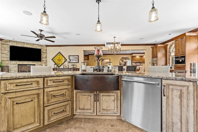 kitchen featuring stainless steel dishwasher, ceiling fan with notable chandelier, and pendant lighting