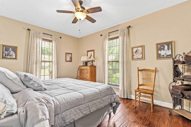 bedroom with ceiling fan and dark hardwood / wood-style flooring