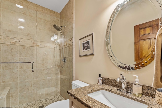 bathroom featuring vanity, toilet, and a shower with shower door