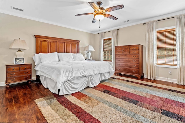 bedroom featuring ceiling fan, dark hardwood / wood-style flooring, and ornamental molding