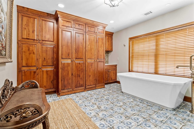 bathroom featuring tile floors and a bath