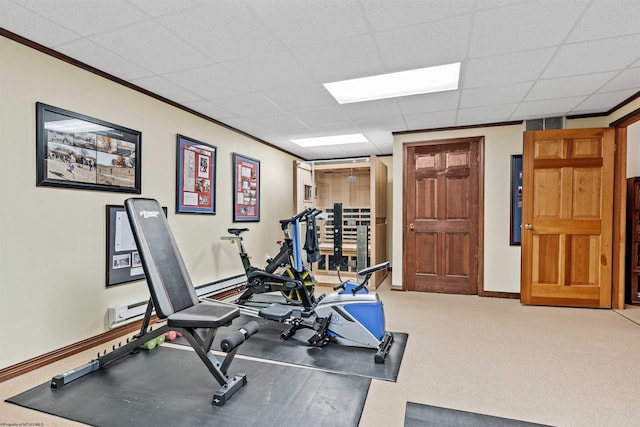 exercise area featuring a paneled ceiling, light colored carpet, and baseboard heating