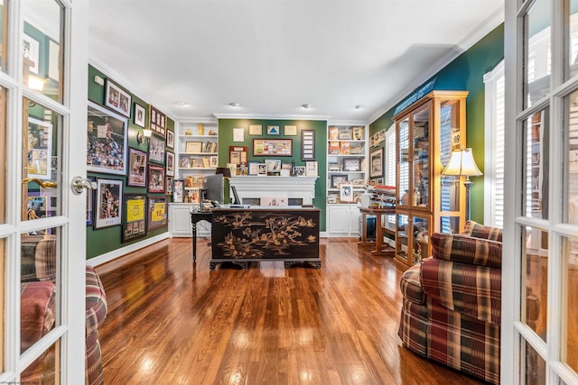 home office with crown molding, built in features, dark wood-type flooring, and french doors