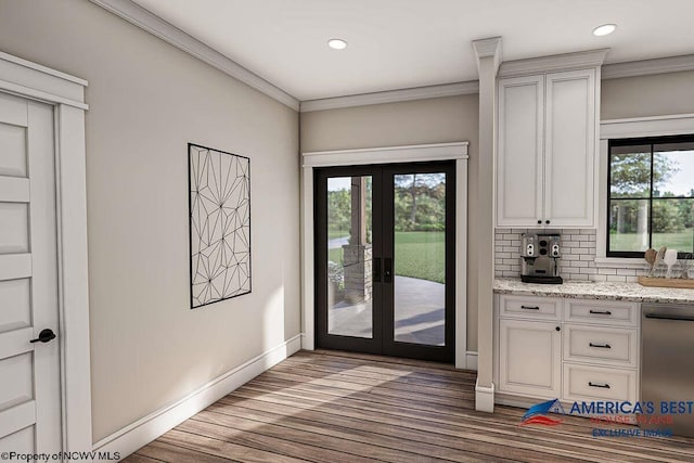 doorway to outside with crown molding, dark hardwood / wood-style flooring, french doors, and a wealth of natural light