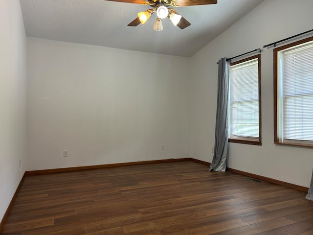 empty room featuring ceiling fan and dark hardwood / wood-style flooring