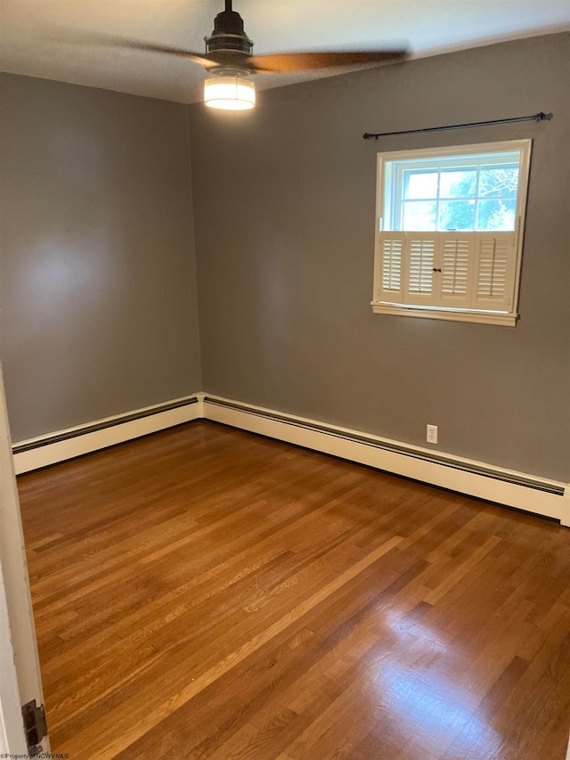 empty room featuring a baseboard radiator, ceiling fan, and hardwood / wood-style flooring