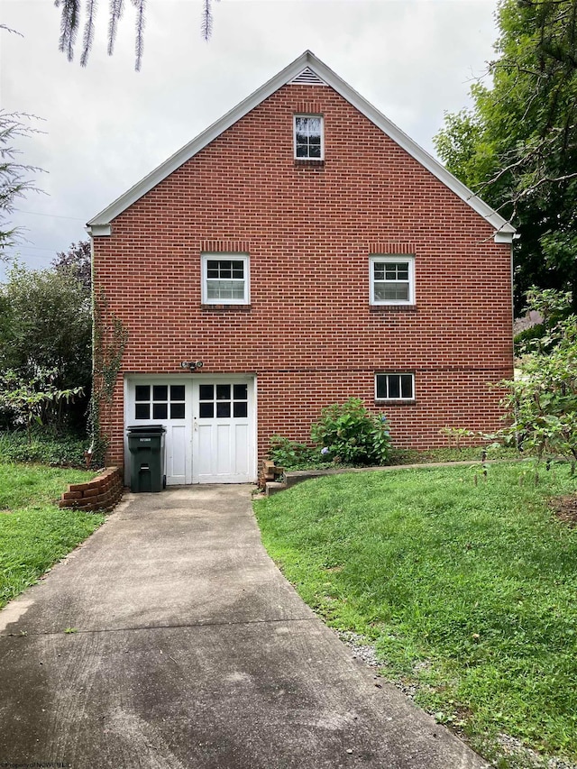 view of side of property featuring a yard and a garage