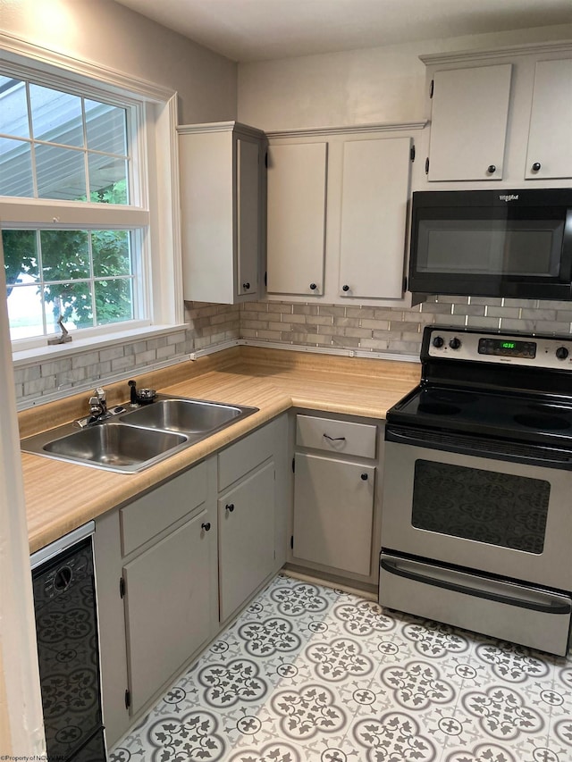 kitchen featuring sink, backsplash, electric stove, and light tile floors