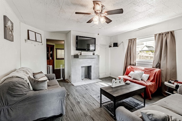 living room with ceiling fan and dark wood-type flooring