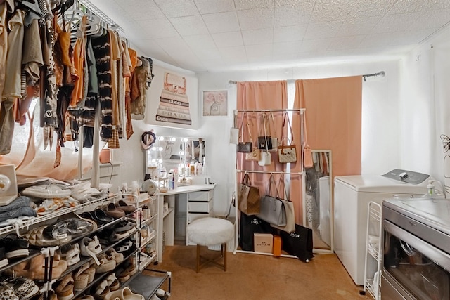 miscellaneous room featuring independent washer and dryer and light colored carpet