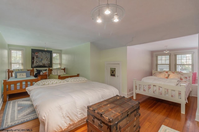 bedroom with wood-type flooring and multiple windows