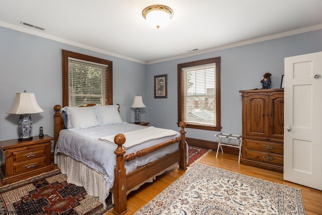 bedroom featuring crown molding and wood-type flooring