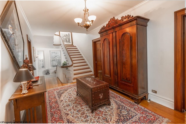 interior space with hardwood / wood-style floors, a notable chandelier, and crown molding