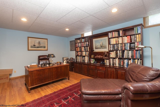 home office with hardwood / wood-style floors and a drop ceiling