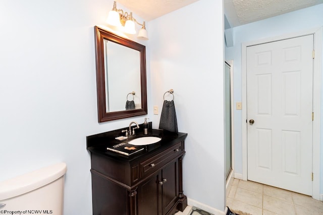 bathroom featuring walk in shower, toilet, tile flooring, a textured ceiling, and vanity