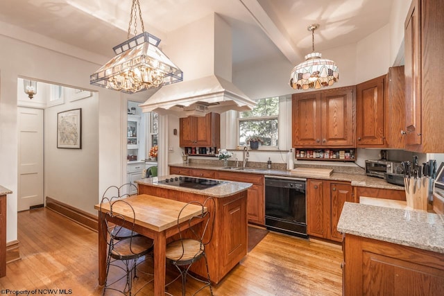 kitchen featuring island range hood, black appliances, sink, light stone counters, and light hardwood / wood-style floors