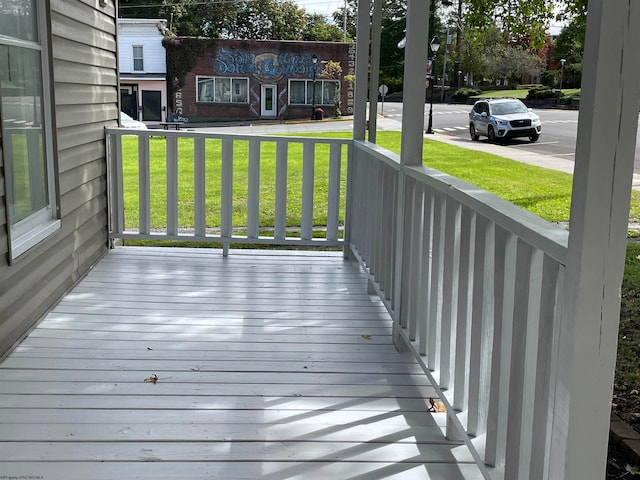 wooden deck featuring a yard and a porch