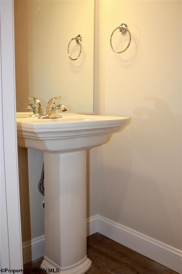 bathroom featuring wood-type flooring and sink