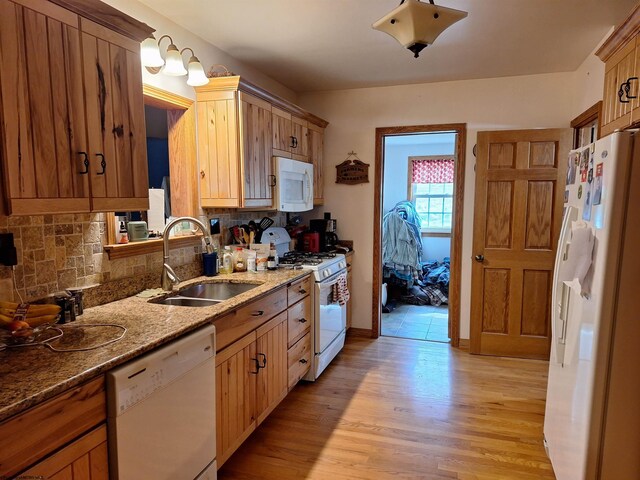 583 Gallop Run Rd, Lost Creek, WV 26385 - kitchen featuring sink, light hardwood / wood-style flooring, backsplash, white appliances, and stone counters